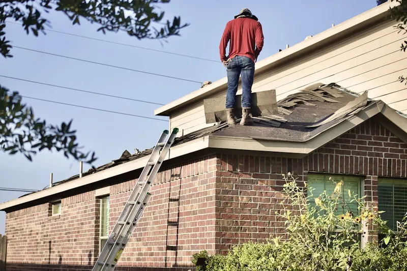 Professional roofer working on a residential roof in White Mill Crossing